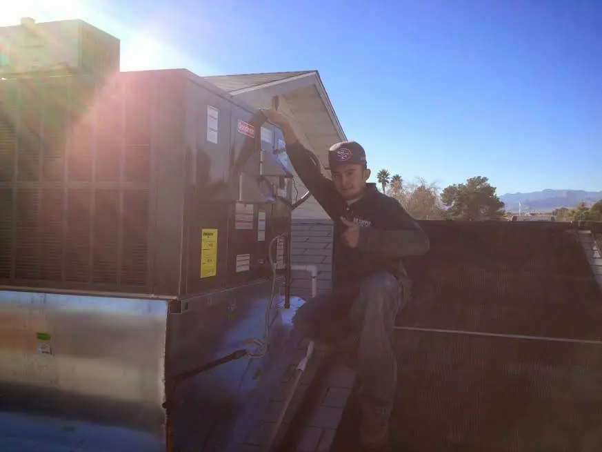 HVAC technician performing HVAC Inspection on a rooftop unit in Dublin